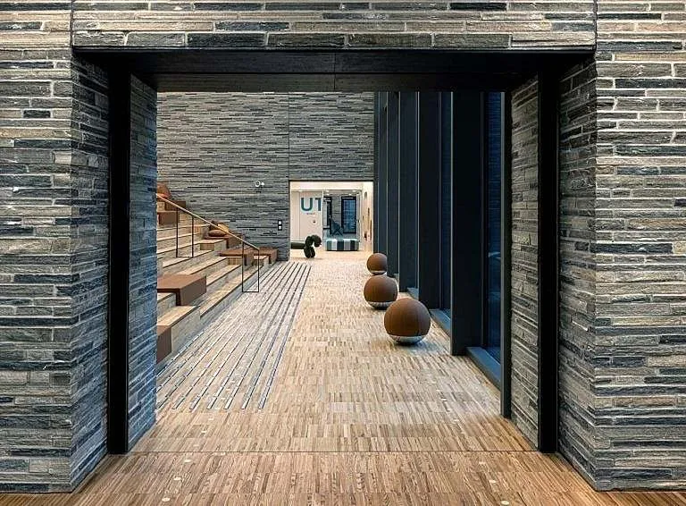 Patio de acceso de Glassblokkene con revestimiento de pizarra y suelo de madera