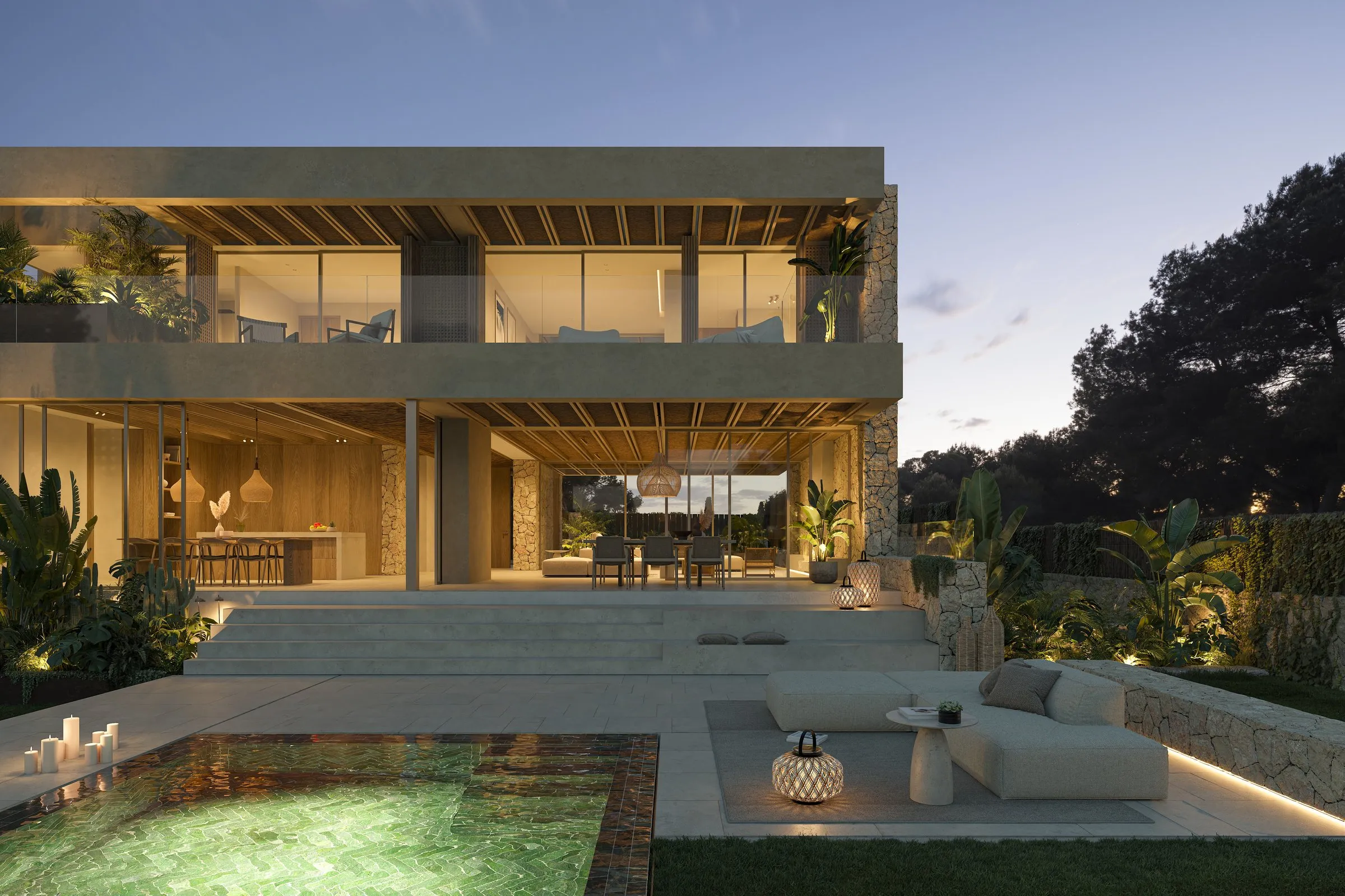 Piscina y fachada iluminada de la vivienda Tagomago en Santa Ponça, al anochecer